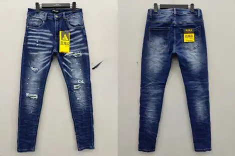 Jean Homme slim bleu délavé déchirures et taches blanches.